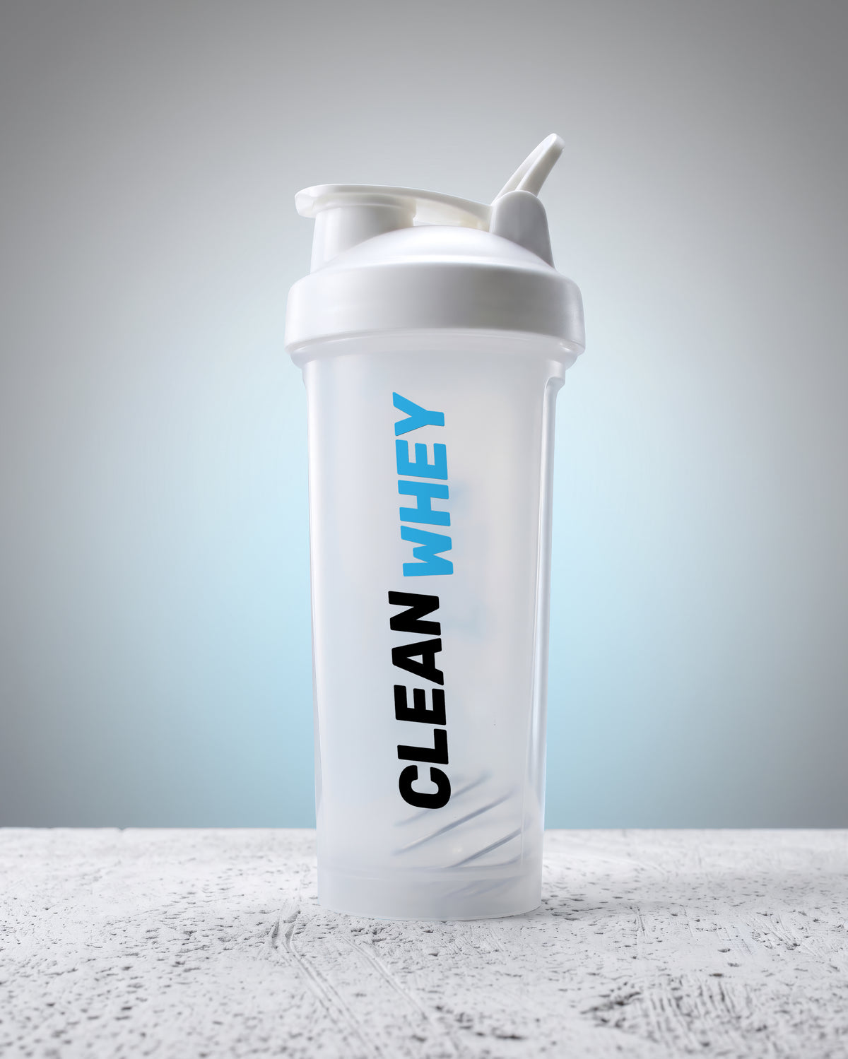 A translucent white shaker bottle with a white lid and straw, featuring the vertical text 'CLEAN WHEY' in black and blue, set against a soft gray gradient background.