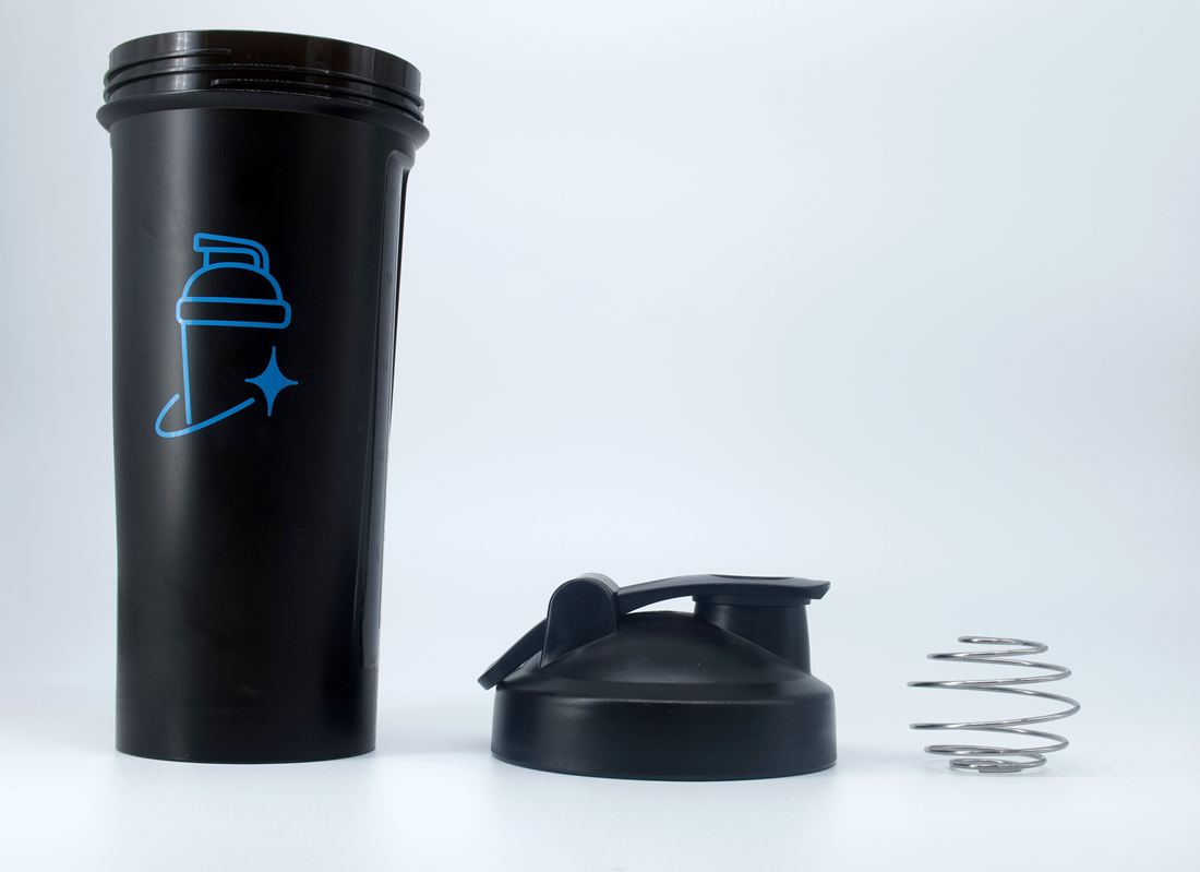 Disassembled Clean Whey shaker: cup, flip lid and spring mixing ball